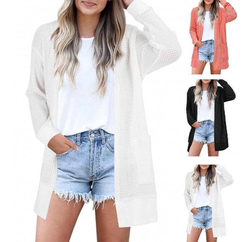 White loose knit cardigan with open front and long sleeves, hip-length
