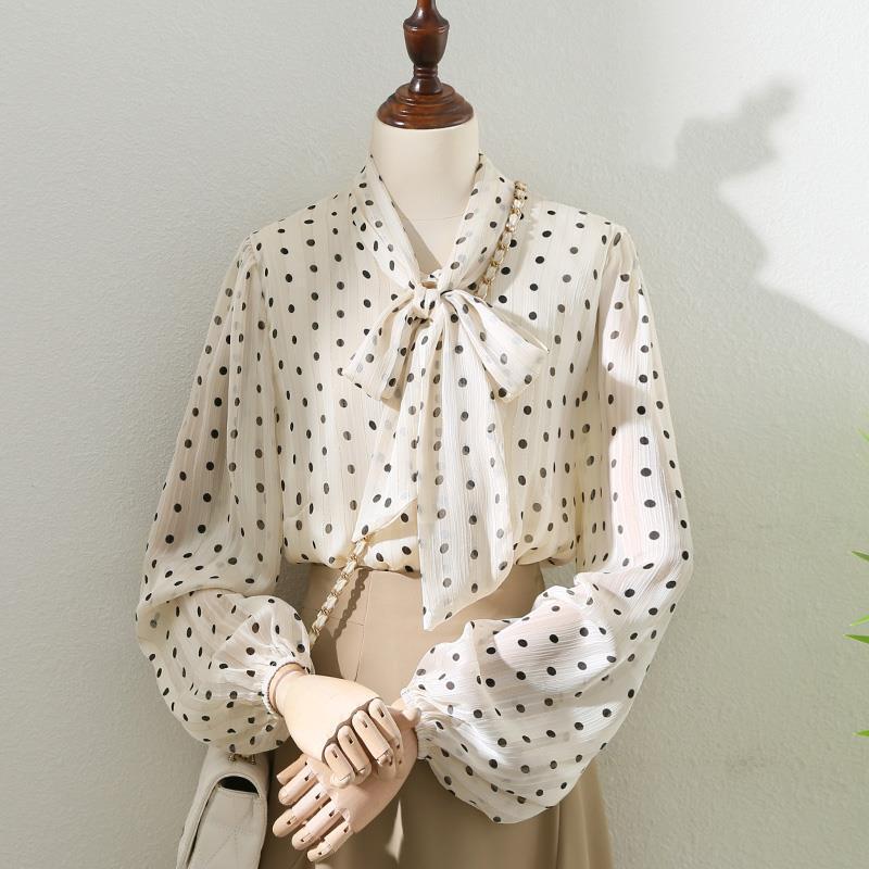 Women’s polka dot blouse with tied bow neck and sheer long puff sleeves
