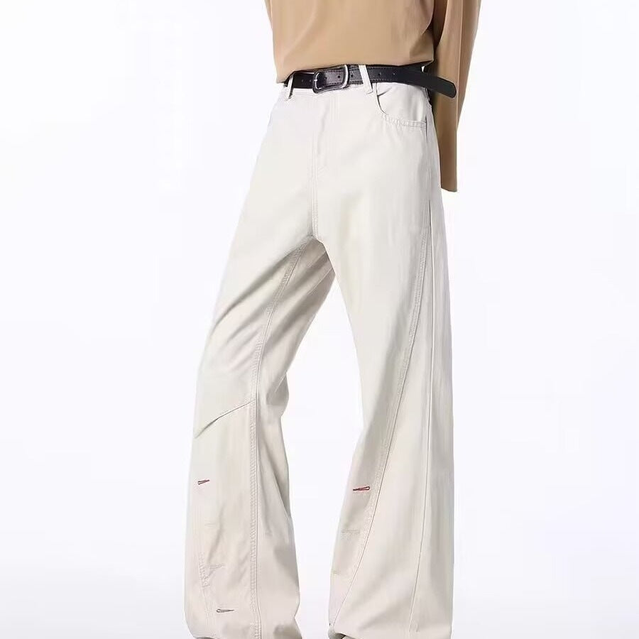 Men's off-white bootcut jeans with button-fly and side zipper, close-up front