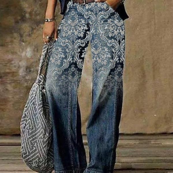 Blue denim jeans with ornate swirling pattern at upper legs, wide-leg casual fit
