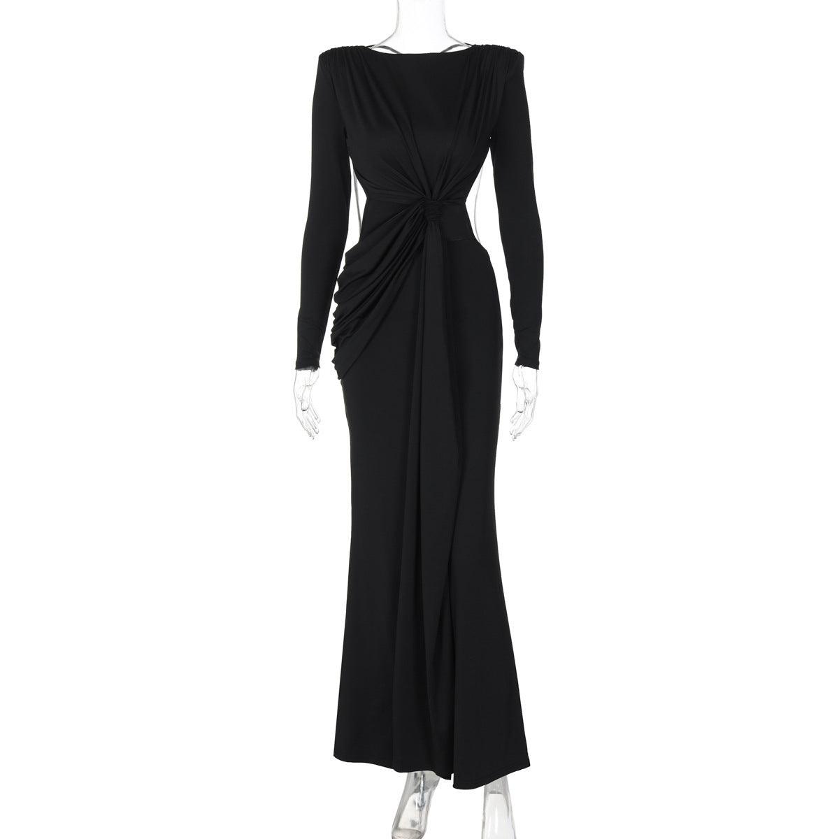 Black long-sleeve maxi dress with ruched back knot and straight, floor-length silhouette.