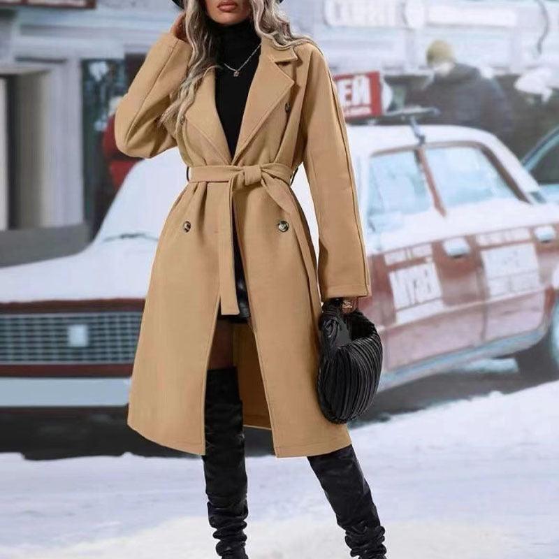 Beige double-breasted trench coat with notched lapels, belt tie, and side pockets