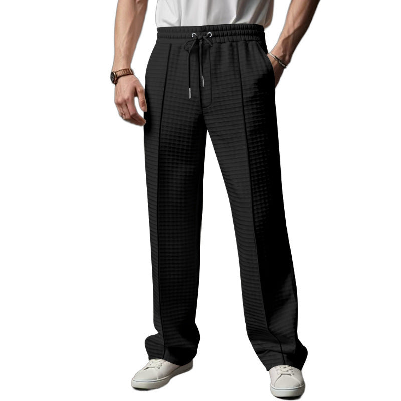 Black jogger trousers with elastic waistband and black drawstring, subtle check texture.