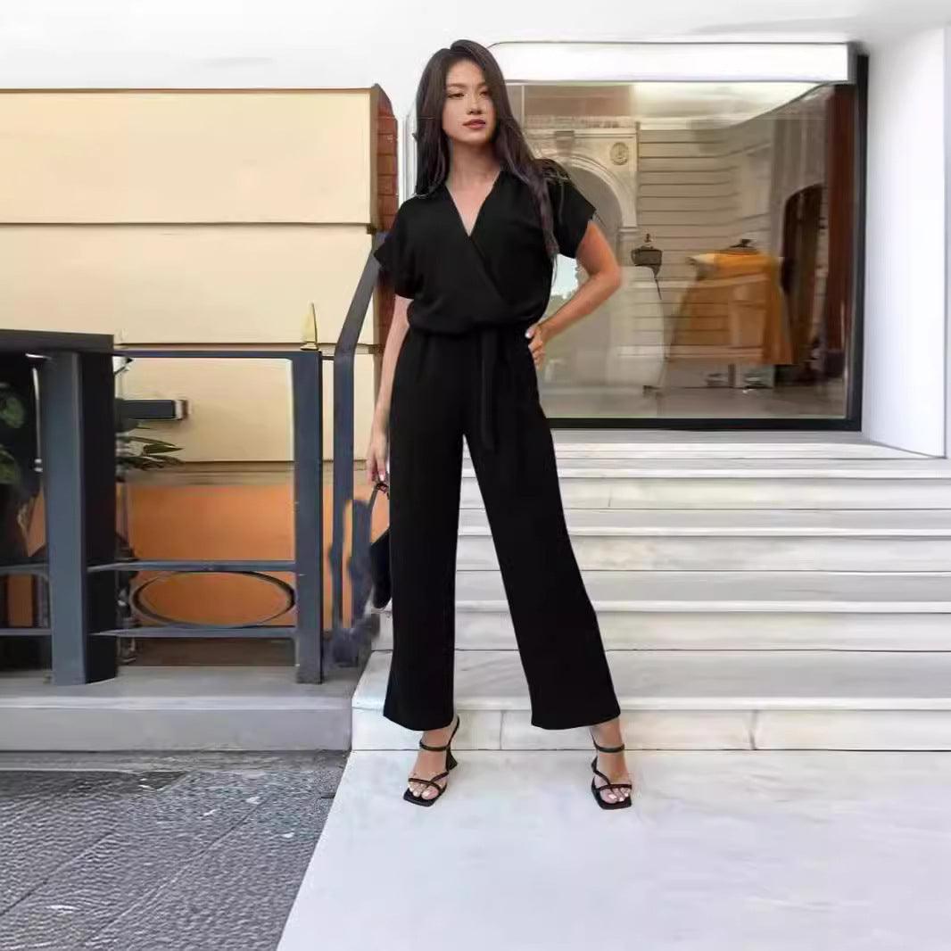 Black short-sleeve V-neck pocket jumpsuit with waist tie and wide-leg pants