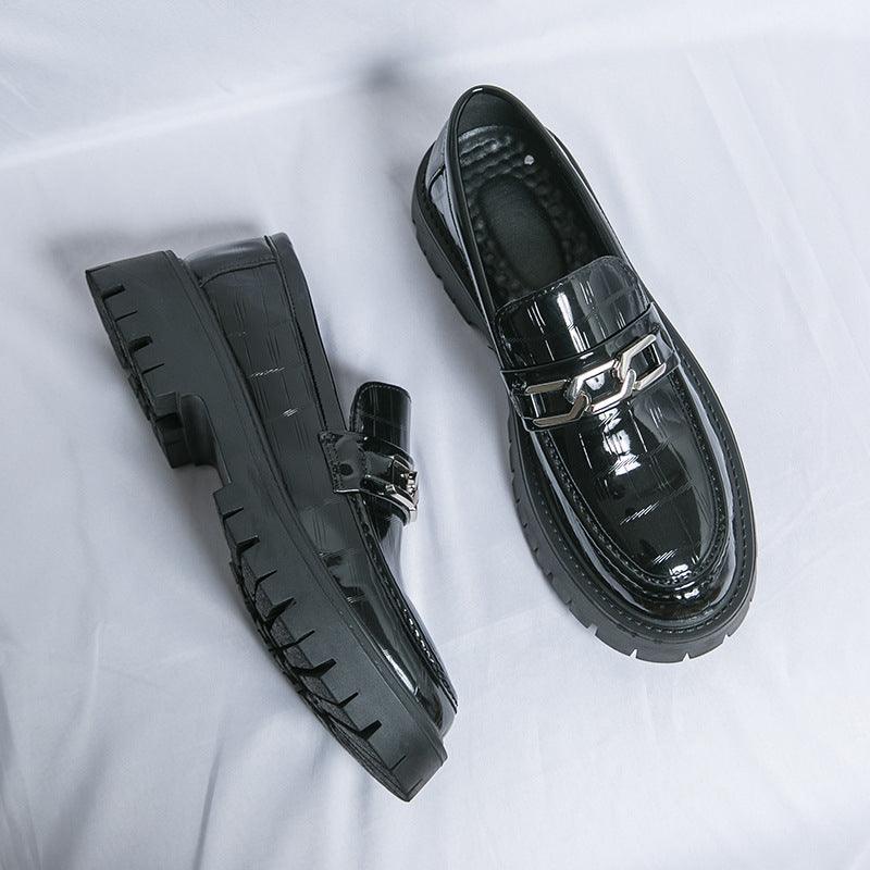 Black glossy leather loafers with double buckle straps and thick tread sole