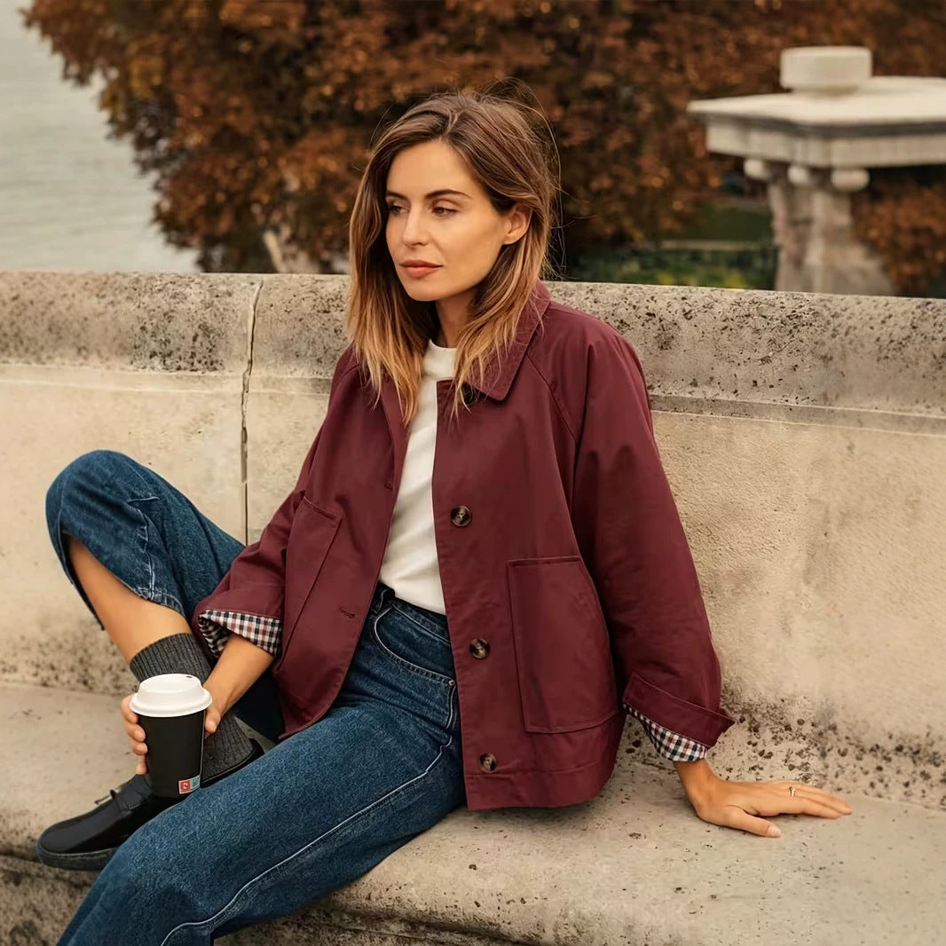 Women’s burgundy casual jacket with button front, flap pockets, and plaid-lined cuffs