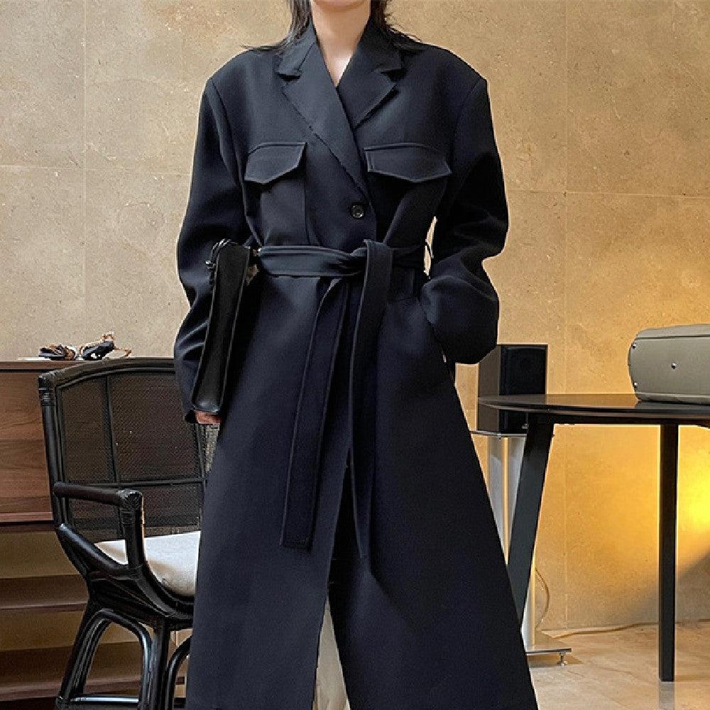 Black long casual coat with pointed collar, button front, and self-tie belt