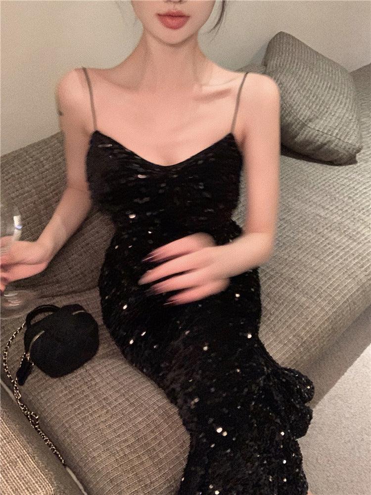 Black sequin spaghetti-strap slip dress with a V-shaped neckline, fitted.