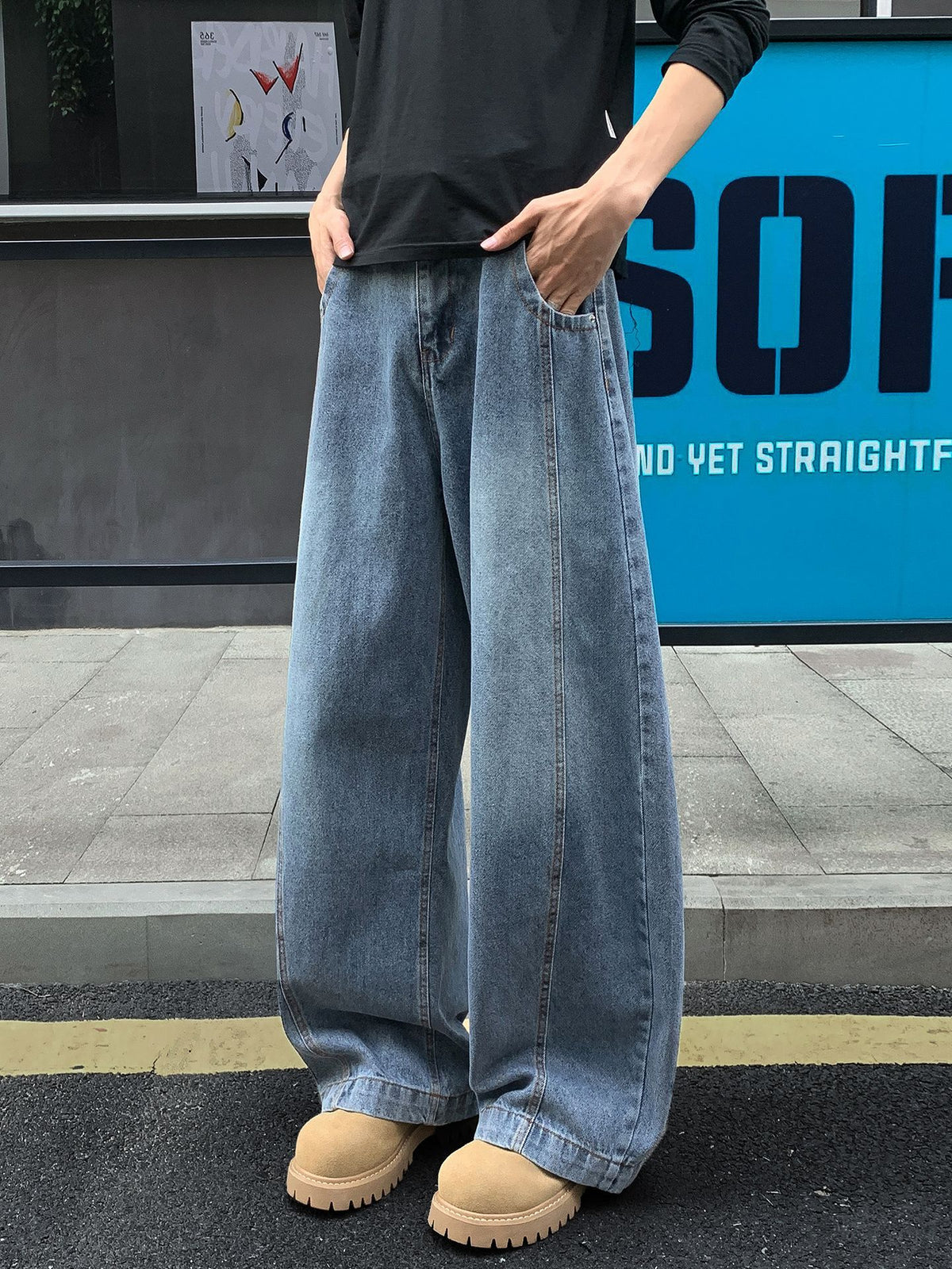 Men's light blue bootcut jeans with relaxed fit and visible front pockets