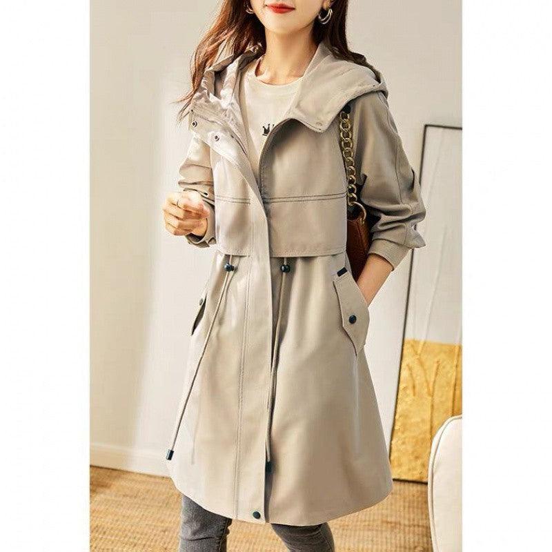 Beige hooded windbreaker overcoat with button front, pockets, and drawstring waist