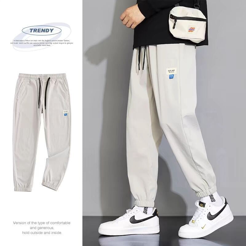White draping sports jogger pants with elastic ankle cuffs and drawstring waist