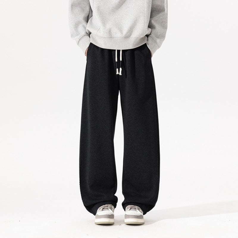 Men's black wide-leg casual pants with elastic waistband and hanging drawstring ties