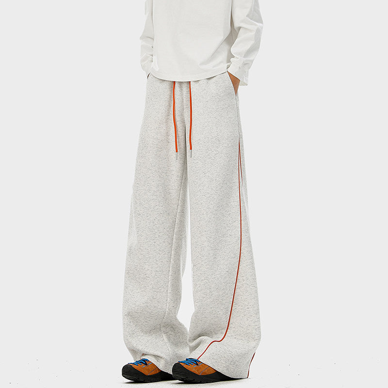 Light gray sports sweatpants with orange stripe piping and drawstring cuffs