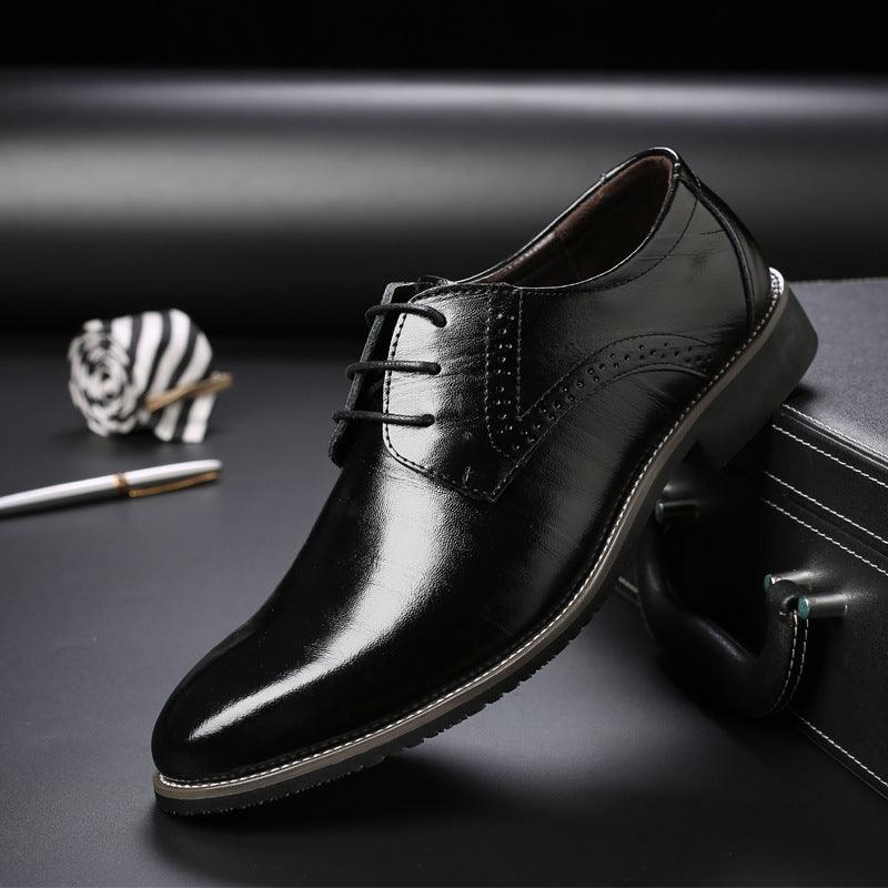 Black leather lace-up dress shoes with stitched brogue detailing and rounded toe