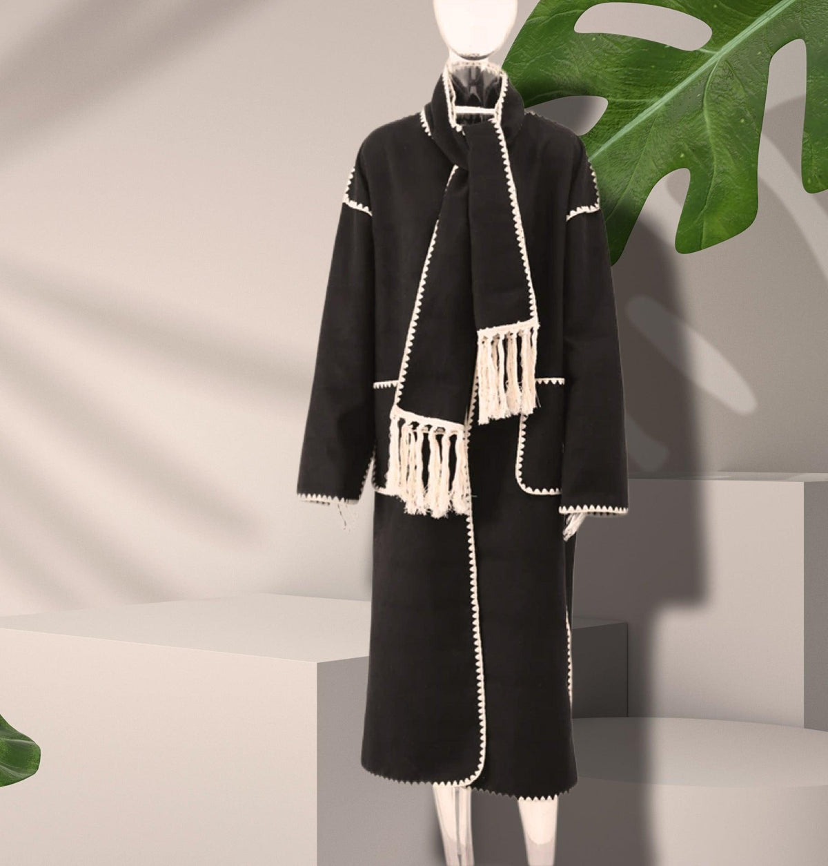 Women's black long wool coat with contrast white edging and tassel lace trim