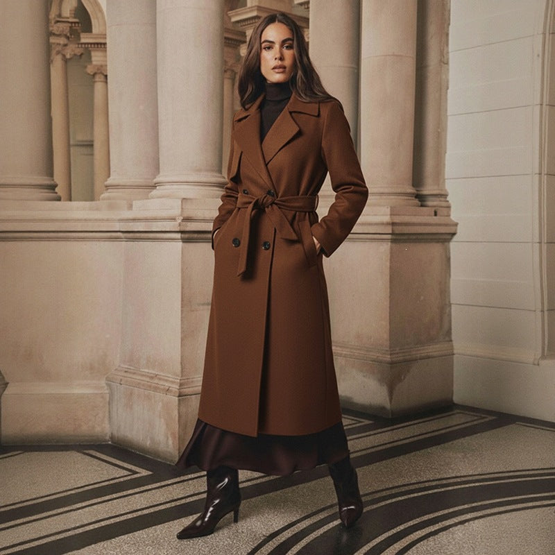 Women’s brown long tie trench coat with notched lapels and belted waist, button closure