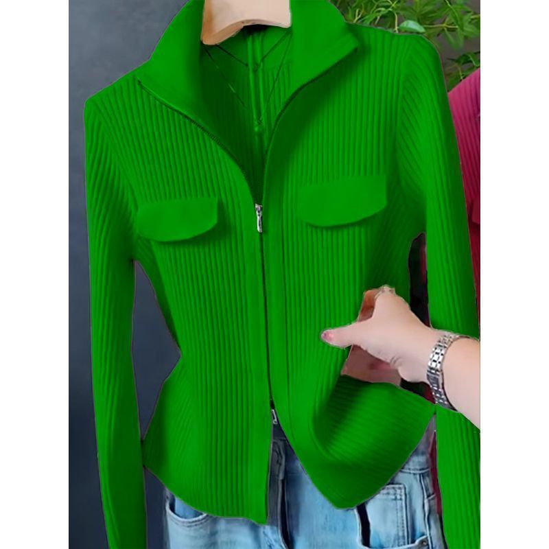 Green zip-up sweater with stand collar, zipper front, and two chest patch pockets