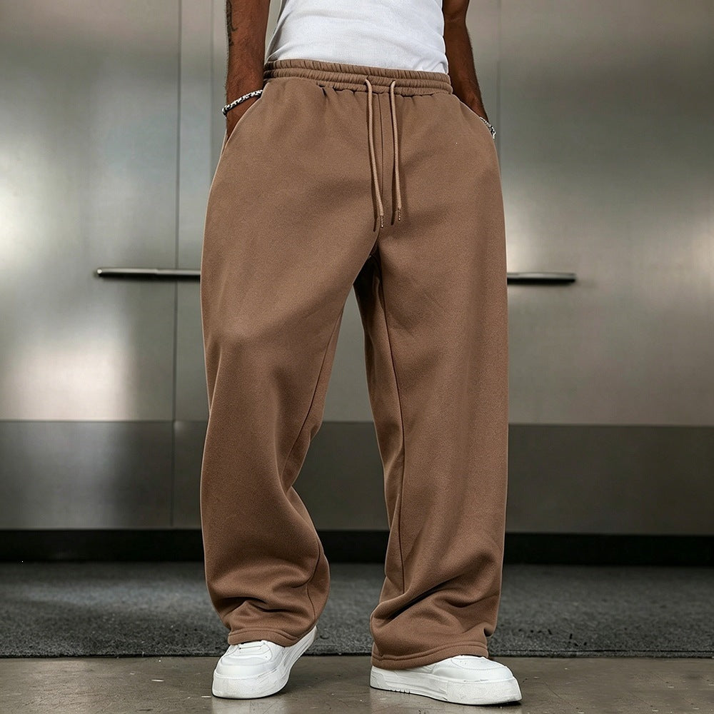 Brown elastic-waist sweatpants with drawstring, loose straight legs and ankle cuffs.