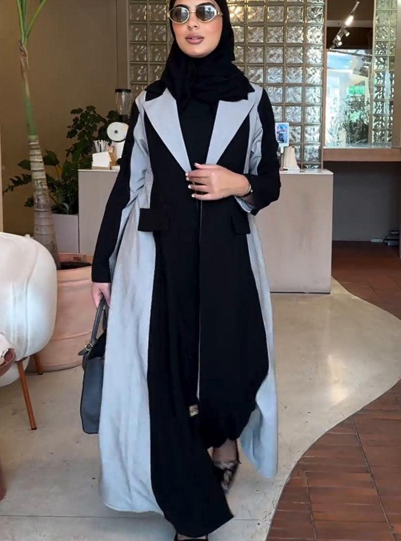 Mid-length trench coat with light gray contrast panels, front buttons, flowing hem
