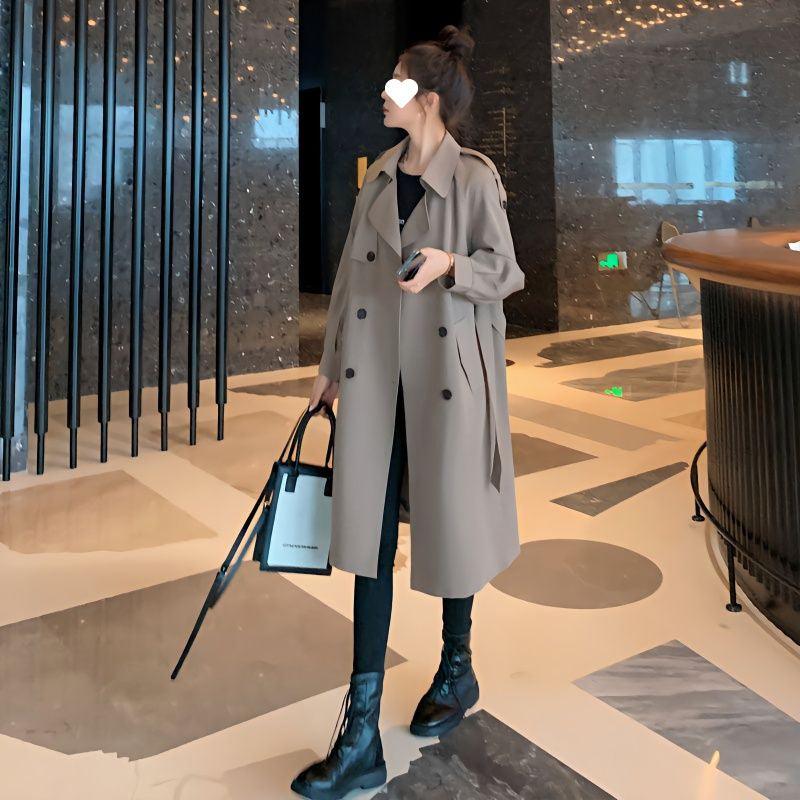 Light gray mid-length trench coat with double-breasted buttons and lapel collar