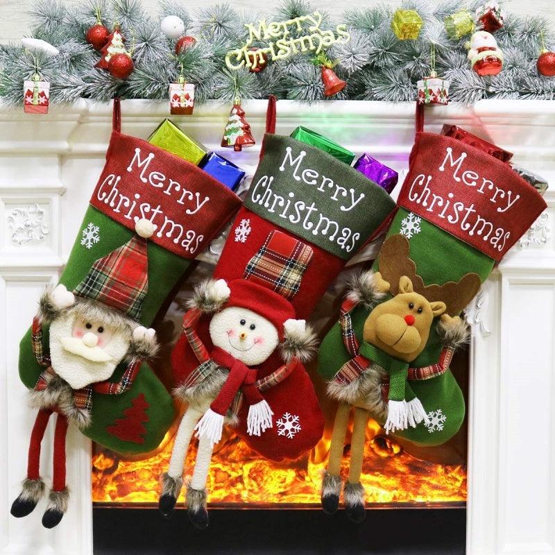 Set of three Christmas stockings: old man, snowman, and reindeer plush, “Merry Christmas” text.