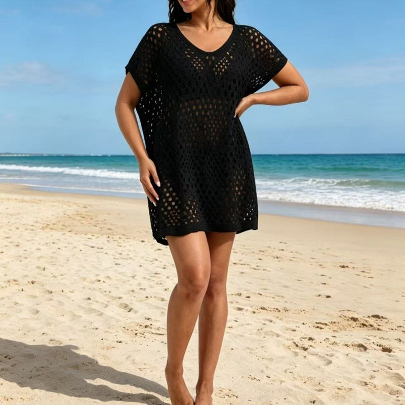 Black round-neck hollow-out pullover blouse with short sleeves and loose tunic fit