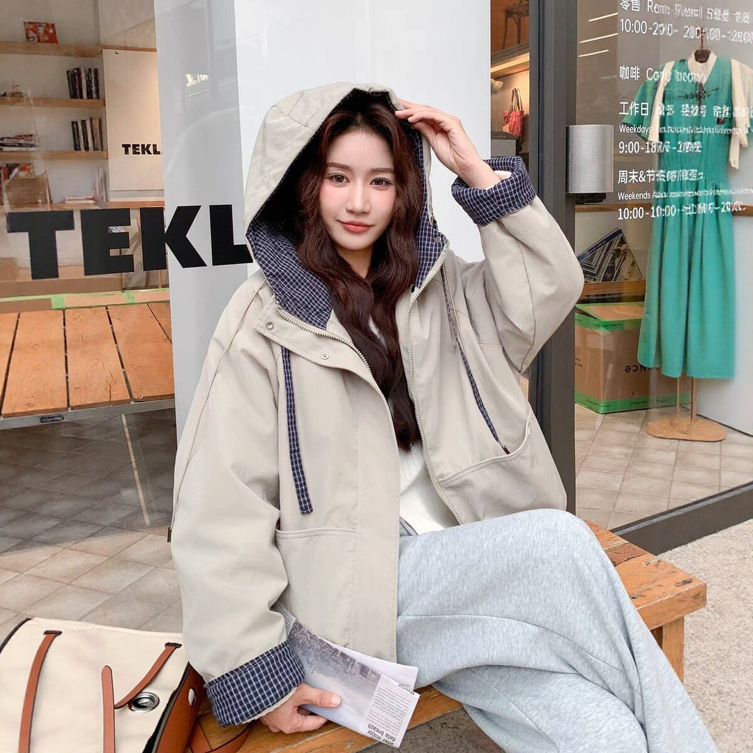 Women's hooded short coat in beige with patchwork hood lining and zip front.