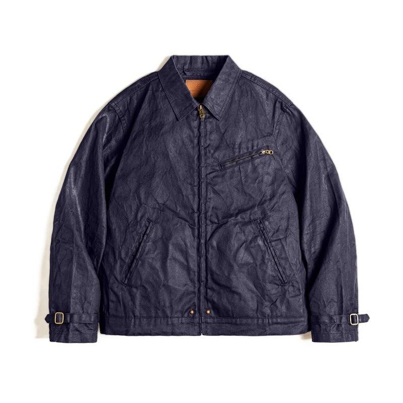 Dark blue canvas oil wax jacket with zip front, stand collar, and chest zipper pocket.