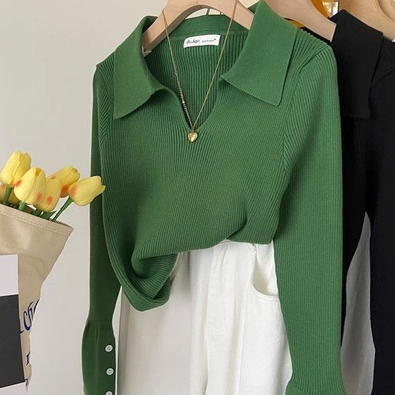 Green ribbed knit sweater with collared neckline and button placket, long sleeve.