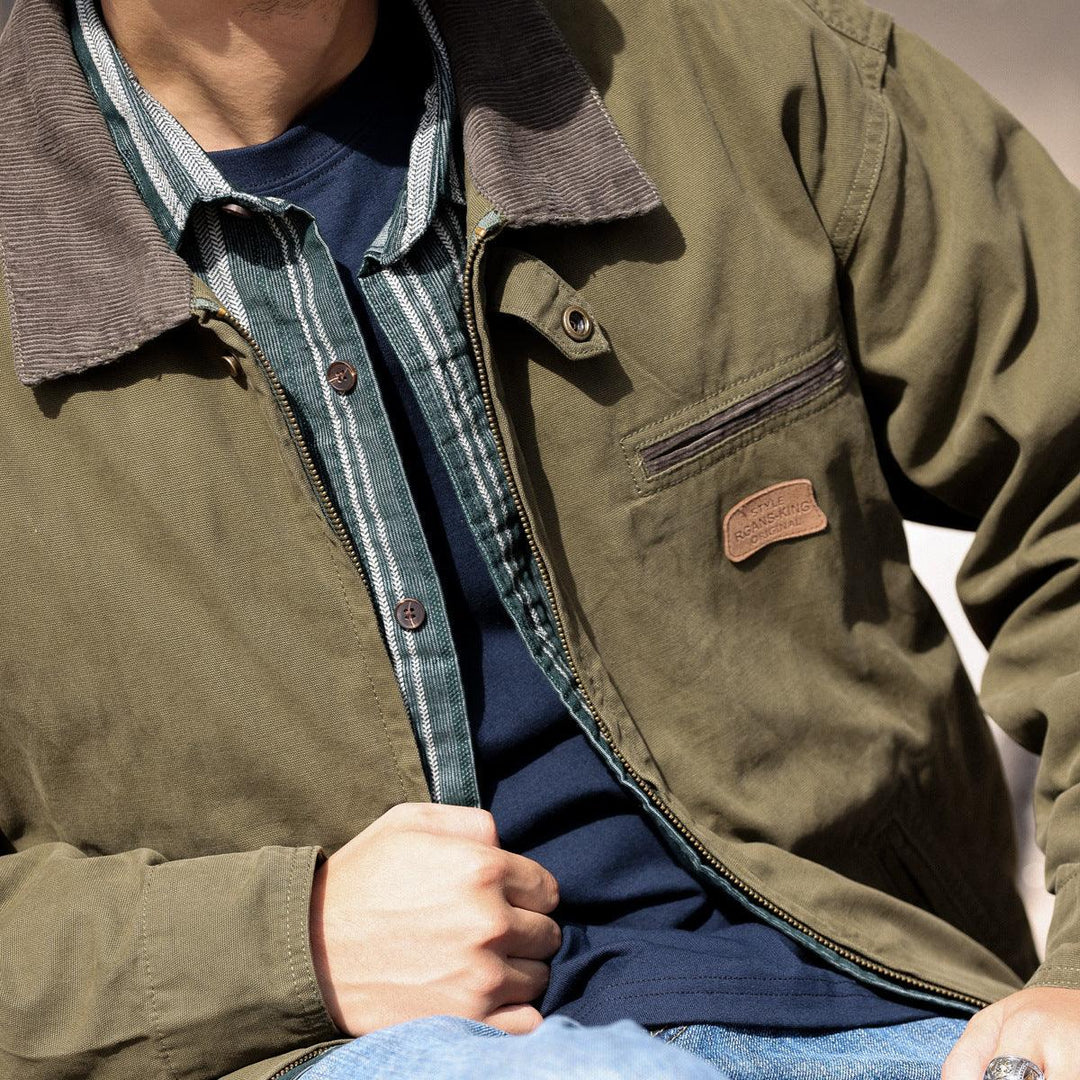 Army green heavy canvas jacket with zip front, snap placket, and chest pocket patch