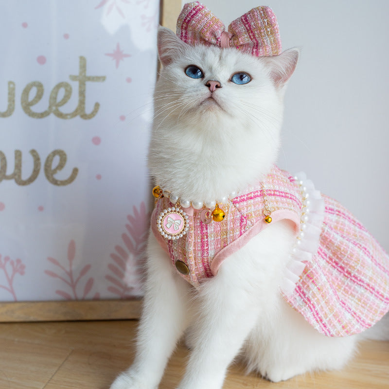 Pink tweed cat dress with bow headdress, pearl trim, and charm necklace detail