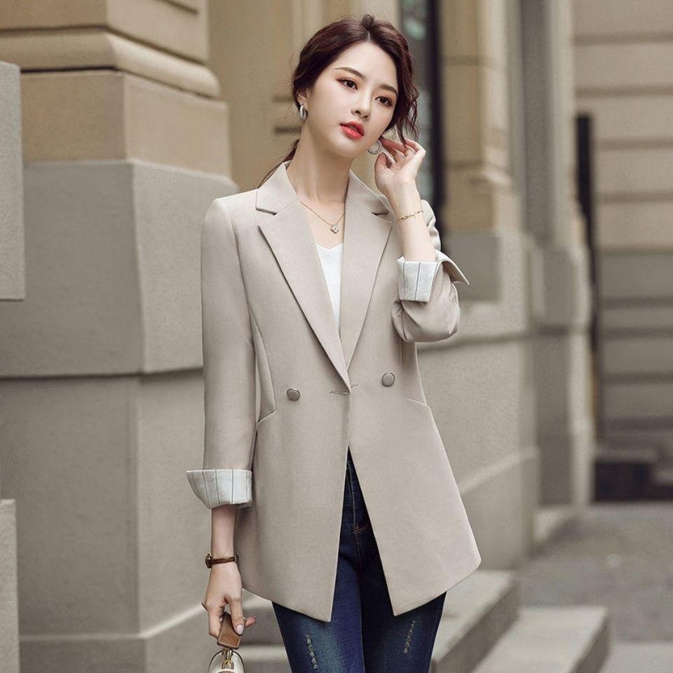 Women’s beige blazer with notched lapels, double buttons, and cuffed sleeves