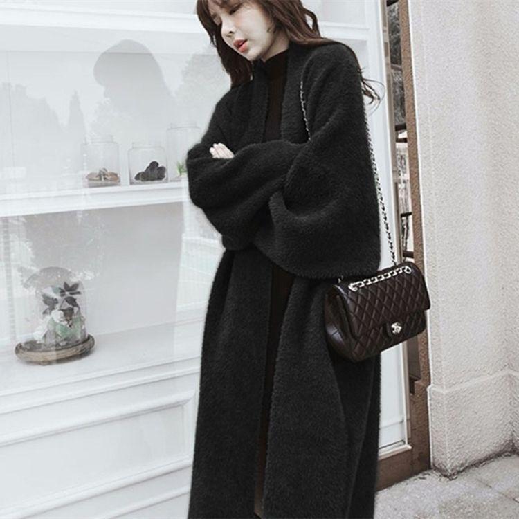 Black long fuzzy sweater with open front and belt, long sleeves.