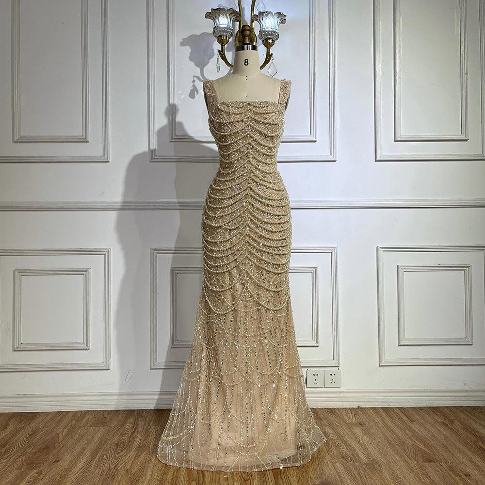 Champagne gold pearl beaded gown on mannequin, strapless look and long layered skirt