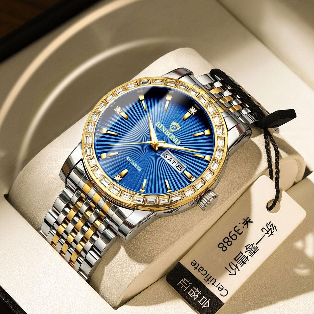 Two-tone metal mens wristwatch with blue dial, gold bezel, and link bracelet.