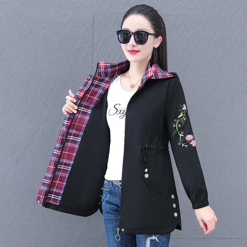 Women's hooded mid-length trench coat in black, drawstring front pockets and floral embroidered sleeves