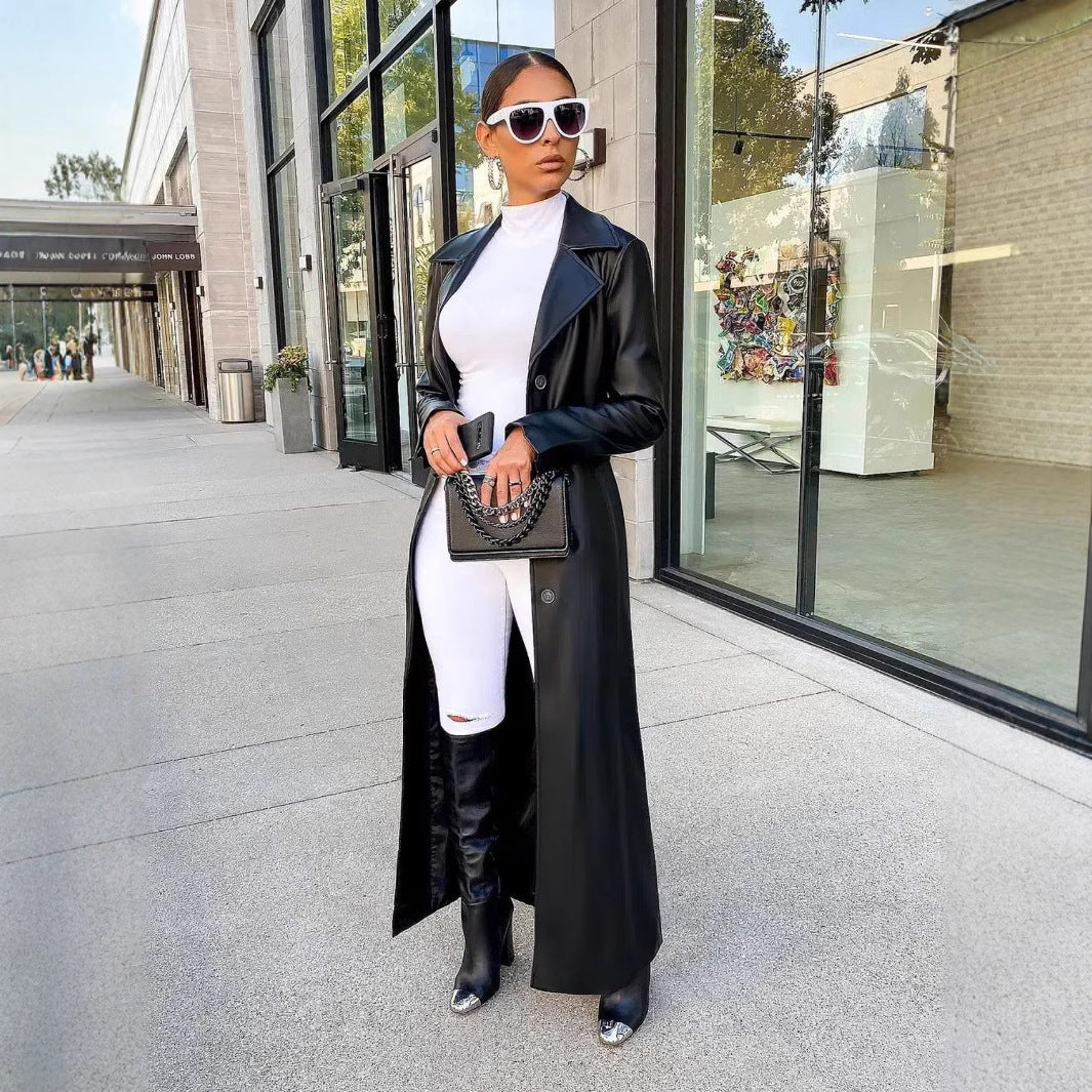 Long black leather coat with lapels and button front, long sleeves and side slit hem