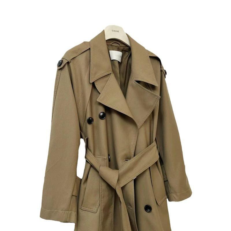 Classic khaki double-breasted coat close-up with wide lapels, belt tie, and buttons