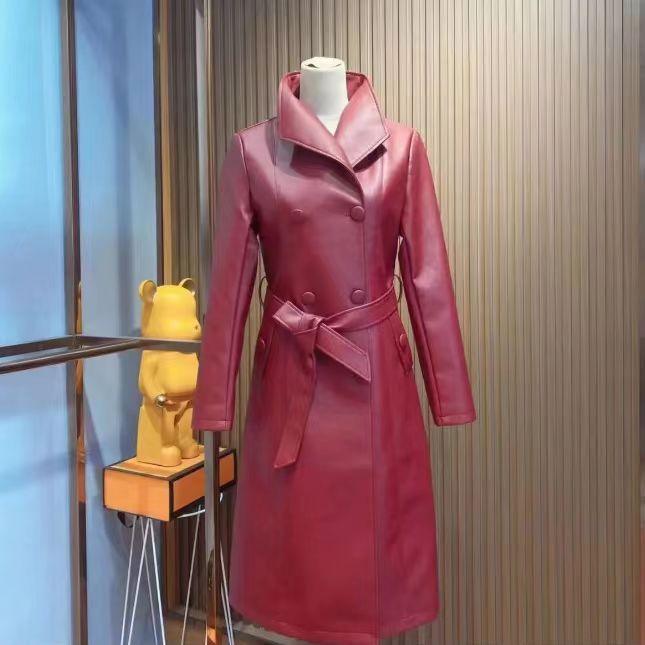 Women's red leather-look coat with classic collar, waist belt, and double-breasted buttons