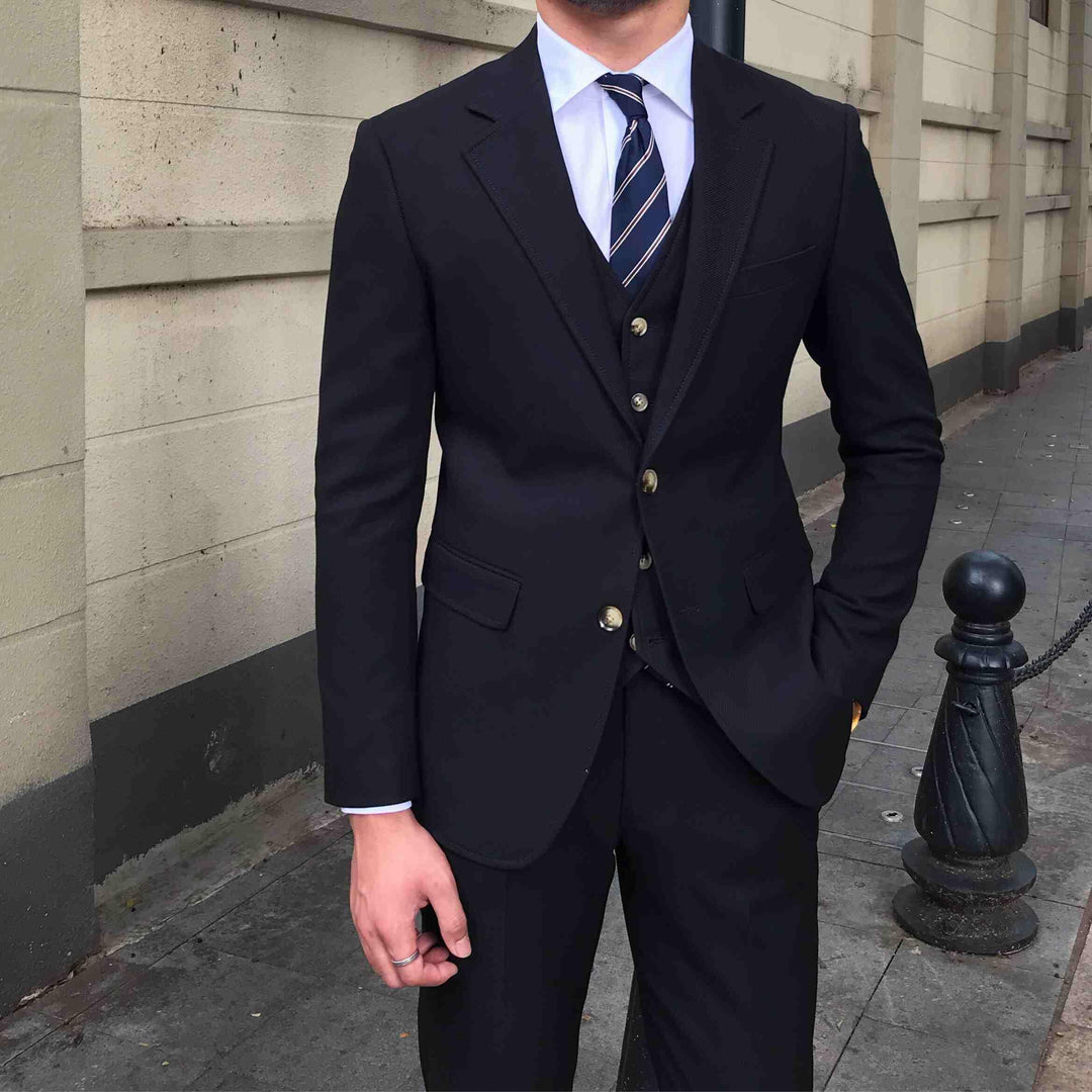 Men's slim-fit three-piece suit jacket and vest, dark color, striped tie