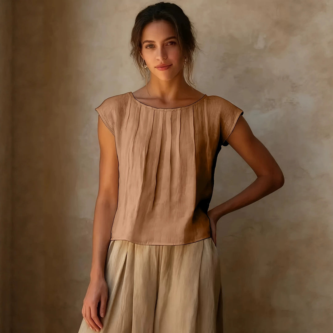 Apricot sleeveless round-neck top with vertical pleats and short cap sleeves
