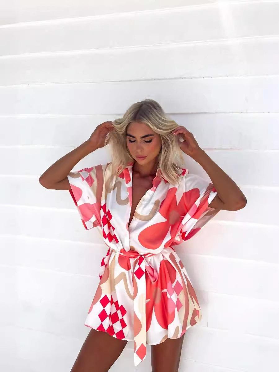 Geometric printed lace-up jumpsuit, white and red, V-neck with tie waist, short sleeves