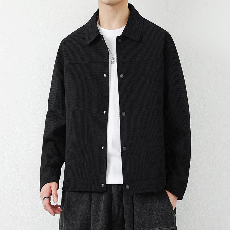 Lapel cardigan jacket in black, button-front placket and chest pockets, textured knit.