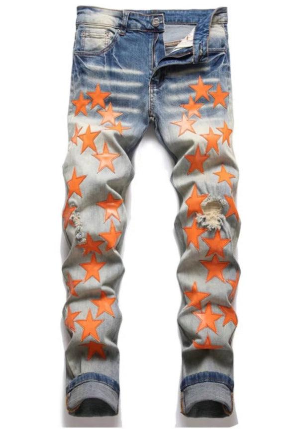 Blue slim jeans with orange star graphic print and ripped, distressed legs