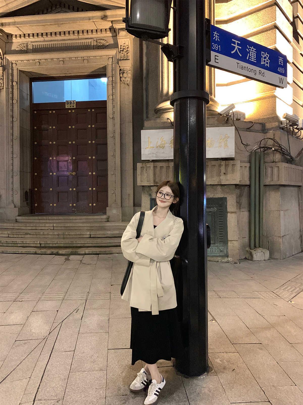 Light apricot small coat with stand collar, long sleeves, front standing pose
