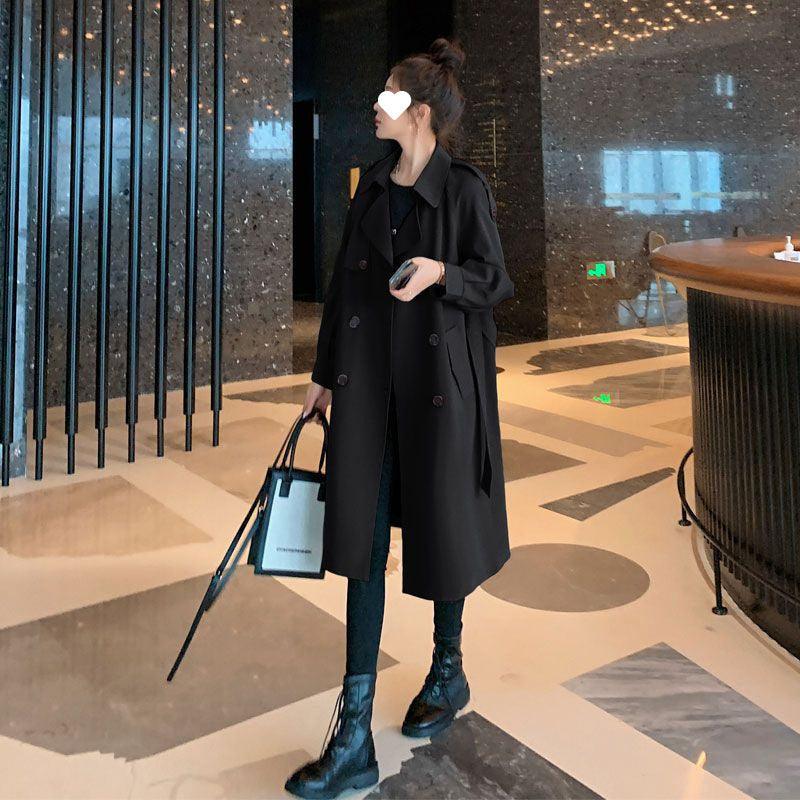 Black mid-length trench coat with belt tie, double-breasted buttons and lapel collar