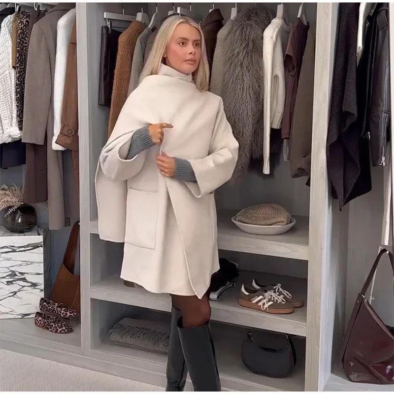 Milky white women's wool coat with high collar and belt with gold buckle, side view