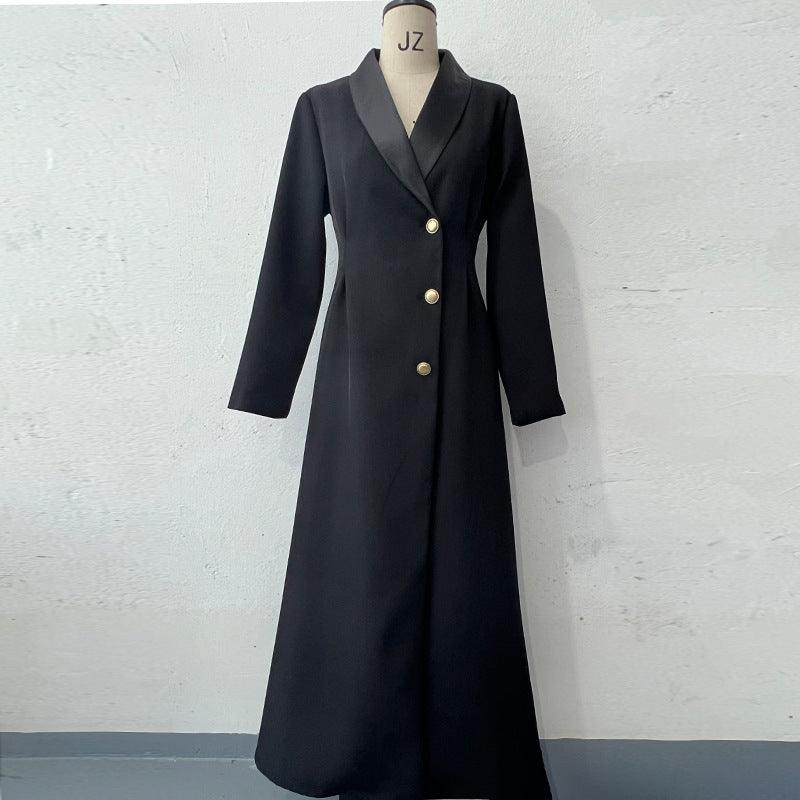 Black long single-breasted coat on mannequin with notched lapels and gold buttons