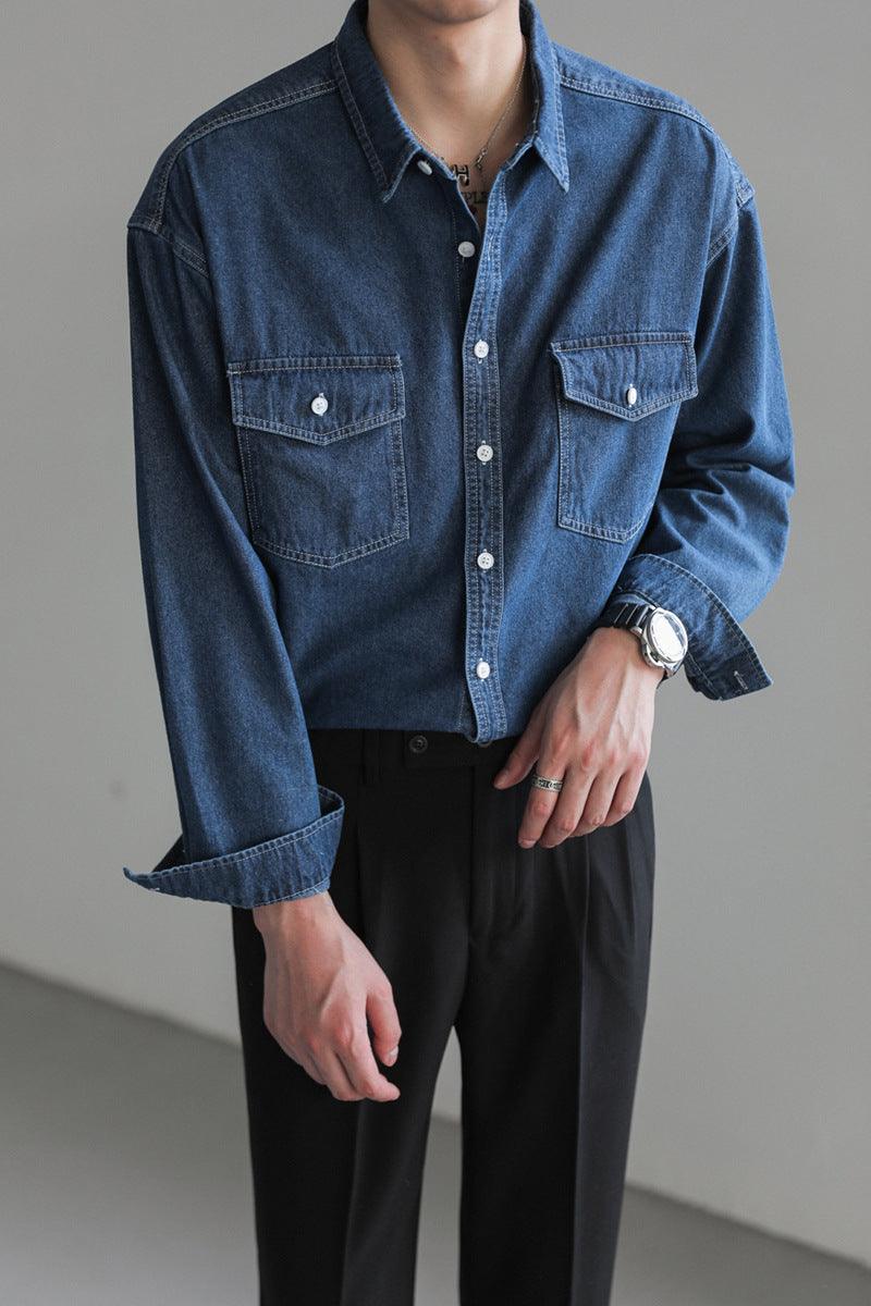 Men's loose dark blue denim button-up shirt with chest pockets and long sleeves