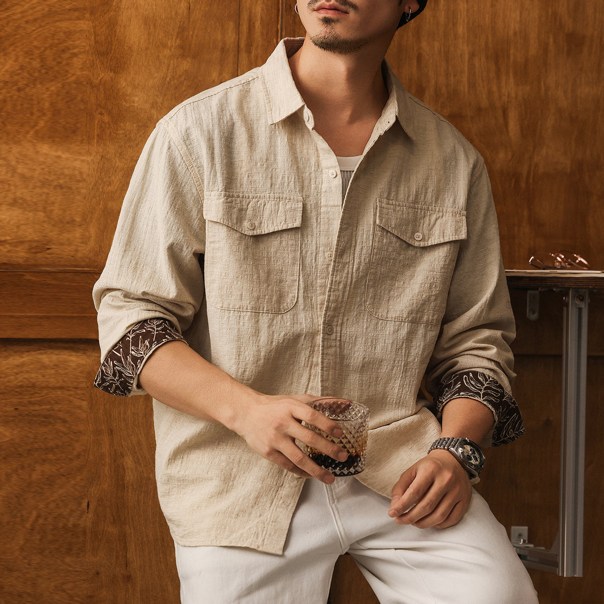 Men's light beige linen button-up shirt with pointed collar and flap chest pockets